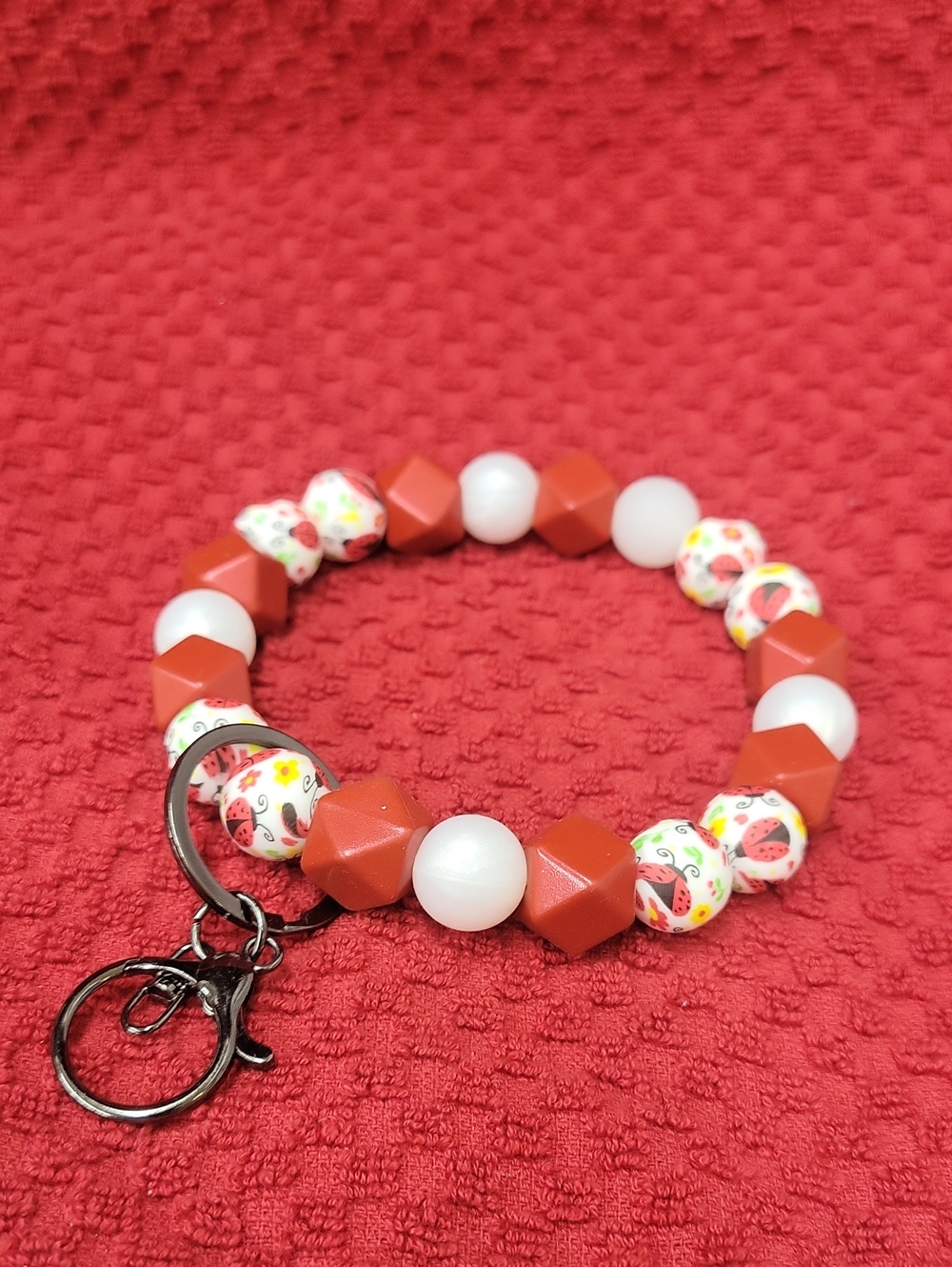 Handmade Red and White Beaded Bracelet with Lady Bug Print Accent